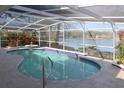 Relaxing screened-in pool with lake view at 1001 Willa Lake Cir, Oviedo, FL 32765