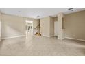 Bright living room with tile floors and a staircase at 10962 Willow Ridge Loop, Orlando, FL 32825