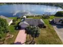 Aerial view of home with lake access showcasing lush landscaping, large lot, and private dock at 1320 Cove Pl, Tavares, FL 32778