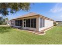 Enclosed back porch featuring a row of windows and a door to the outside at 13914 Se 96Th Cir, Summerfield, FL 34491