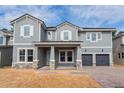 Two-story home with gray siding and a three-car garage at 14261 Crest Palm Ave, Windermere, FL 34786