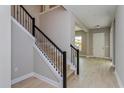 Modern staircase with black metal railing and hardwood steps at 14261 Crest Palm Ave, Windermere, FL 34786