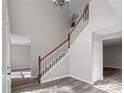 Open-concept foyer featuring staircase, wood floors, and contemporary design at 1617 Myrtle Lake Ave, Fruitland Park, FL 34731