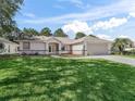 Lovely single story home features a lush green lawn and neutral color palette at 17180 Se 115Th Terrace Rd, Summerfield, FL 34491