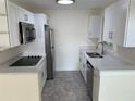 Renovated kitchen featuring modern appliances and cabinetry at 17202 Sandalwood Dr # 202, Wildwood, FL 34785