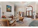 Elegant foyer features soaring ceilings, tile flooring, and a grand front door, showcasing the home's architectural details at 1825 Myrtle Lake Ave, Fruitland Park, FL 34731