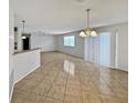 Open-concept living room features lots of natural light, tile floors, and neutral paint tones at 2067 Broyhill Ave, The Villages, FL 32162