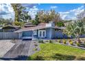 Charming single story home featuring a well-maintained lawn, carport, and elegant landscaping at 2384 Orange Capital Ct, Eustis, FL 32726