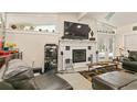 Living room featuring a fireplace, entertainment center, and comfortable leather seating at 2384 Orange Capital Ct, Eustis, FL 32726