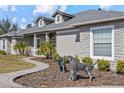 Well-manicured front yard featuring rock facade accents and a concrete walkway at 24429 Adair Ave, Sorrento, FL 32776