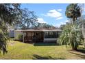 Single-story home with covered porch and deck at 25547 Belle Helene, Leesburg, FL 34748