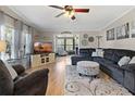 Inviting living room with plush seating, area rug, ceiling fan and view to sun room at 25547 Belle Helene, Leesburg, FL 34748