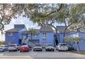 Charming blue condos with stair access, palm trees, and ample parking available at 343 N Mcdonald St # 203, Mount Dora, FL 32757