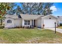 Well-maintained single-story home with a neat front lawn, attached garage, and welcoming entrance at 5338 Tigers Tail, Leesburg, FL 34748