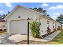 Side view of the house, showcasing garage and landscaping at 5513 Shriver St, Leesburg, FL 34748