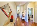 Inviting hallway with hardwood floors and stylish decor, leading to various rooms at 752 Chacall Loop, Mount Dora, FL 32757