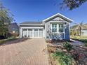 Charming single-Gathering home featuring a two-car garage and a brick driveway at 113 Bayou Bend Rd, Groveland, FL 34736