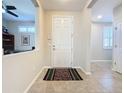 Bright foyer with tile flooring leading to other rooms in the home at 113 Bayou Bend Rd, Groveland, FL 34736