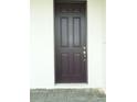 Elegant brown front door featuring detailed paneling and a stylish handle at 14365 Crest Palm Ave, Windermere, FL 34786