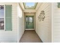 Inviting entryway with a stylish front door, transom window and decorative wall art at 1555 Ward Ct, The Villages, FL 32162