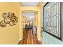 View from entry into a spacious living room with hardwood floors and neutral wall color at 1555 Ward Ct, The Villages, FL 32162