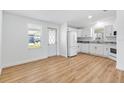 Bright kitchen with new white cabinets, appliances, and wood floor, perfect for cooking and entertaining at 1616 Bayhill Dr, The Villages, FL 32159