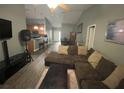 Cozy living room with wood-look floors, vaulted ceiling, and open layout, connecting seamlessly to the kitchen and dining area at 167 N Cervidae Dr, Apopka, FL 32703