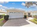 Two-car garage with a clean and well-maintained driveway at 17145 Se 93Rd Yondel Cir, The Villages, FL 32162