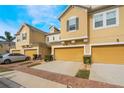 Beautiful townhomes featuring brick-paved driveways and lush landscaping at 17523 Promenade Dr, Clermont, FL 34711