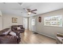 Inviting living room featuring neutral walls, wood-look flooring, and ample natural light at 18415 County Road 33, Groveland, FL 34736
