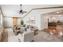 Bright living room features vaulted ceilings, exposed wood beams, and modern furnishings at 2685 Cr 776, Webster, FL 33597