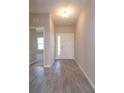 Inviting entryway featuring neutral walls, wood-look tile flooring, and a bright, welcoming atmosphere at 2854 Supermarine Rd, Tavares, FL 32778
