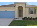 Close up of home's front entrance and 2 car garage at 2854 Supermarine Rd, Tavares, FL 32778