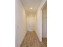 Bright hallway with wood-look tile floors that leads to the rest of the home at 2932 Supermarine Rd, Tavares, FL 32778