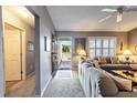 Cozy living room with neutral walls, plush carpet, and a view of the front yard through shuttered windows at 3218 Woodridge Dr, The Villages, FL 32162