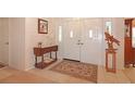 Inviting home entryway featuring a light-filled foyer with decorative rug and console table at 4034 River Crest Cir, Leesburg, FL 34748