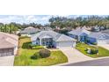 Aerial view highlighting the property in a peaceful neighborhood with mature trees and green spaces at 5095 China Sea Dr, Tavares, FL 32778