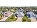 Aerial view showcasing a desirable neighborhood with well-maintained homes and lush green lawns at 5095 China Sea Dr, Tavares, FL 32778