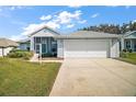 Inviting one-story home with a screened porch and two-car garage on a beautifully landscaped lot at 5095 China Sea Dr, Tavares, FL 32778