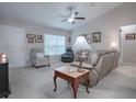 Inviting living room featuring comfortable seating, neutral walls, and natural light from large windows at 51 Almond Rd, Ocala, FL 34472