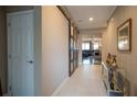 Inviting entryway featuring tile flooring, a decorative barn door and an open view of the living spaces at 525 Narrow View Ln, Groveland, FL 34736