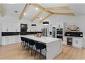 Bright kitchen features white cabinetry, stainless steel appliances, marble countertops, and a large island with seating at 5910 Lake Emma Ct, Groveland, FL 34736