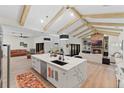 Open floor plan with kitchen island and living room fireplace at 5910 Lake Emma Ct, Groveland, FL 34736