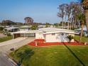 Charming single-story home featuring a covered carport and landscaped front yard at 920 Morningview Dr, Tavares, FL 32778