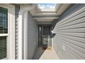 Inviting front entrance featuring neutral siding and a well-sheltered walkway at 5449 Dray Dr, The Villages, FL 32163