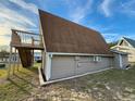 Tan home with a unique architectural style showcasing clean lines and an elevated deck at 10301 Us Highway 27 # 16, Clermont, FL 34711