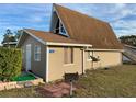 Charming tan home featuring a well-maintained lawn and a distinctive architectural design at 10301 Us Highway 27 # 16, Clermont, FL 34711