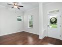 Hardwood floors fill the room, brightened by natural light from the windows, and a ceiling fan overhead at 1041 Linehart Dr, Winter Garden, FL 34787