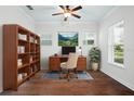 Well-lit home office featuring hardwood floors, a spacious desk area, and a large window overlooking the backyard at 1041 Linehart Dr, Winter Garden, FL 34787