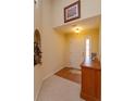 Inviting foyer featuring neutral tones, tile and carpet flooring, and ample natural light at 1123 Bluegrass Dr, Groveland, FL 34736